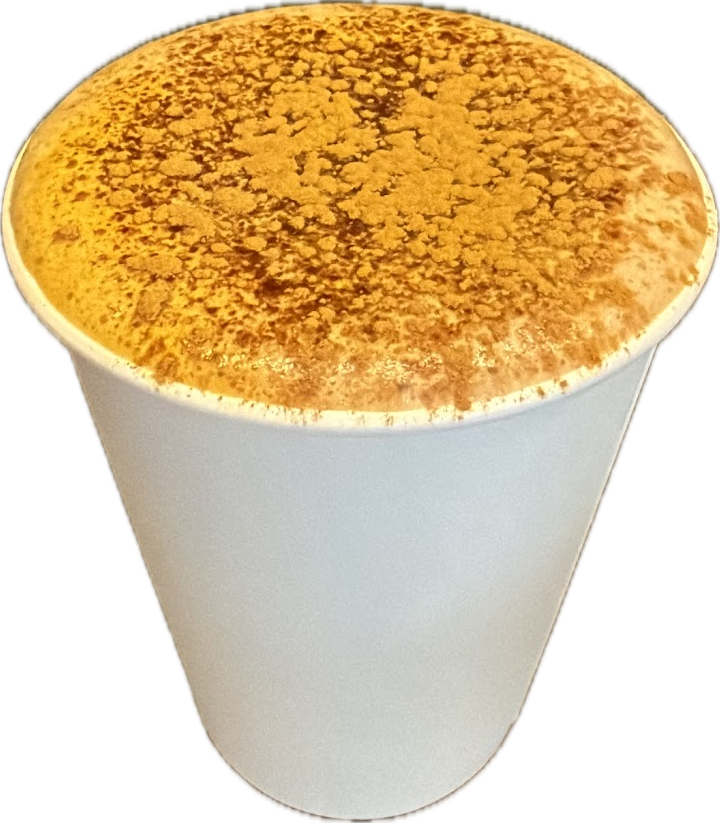A takeaway coffee under a thick cap of foam dusted with cinnamon