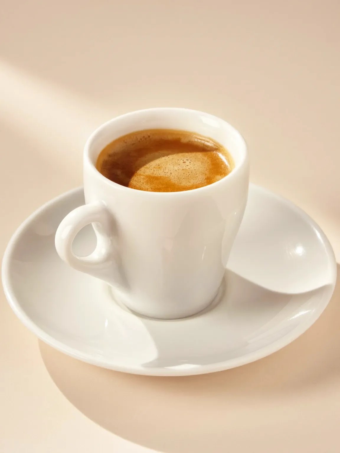 A small espresso in a plain white cup